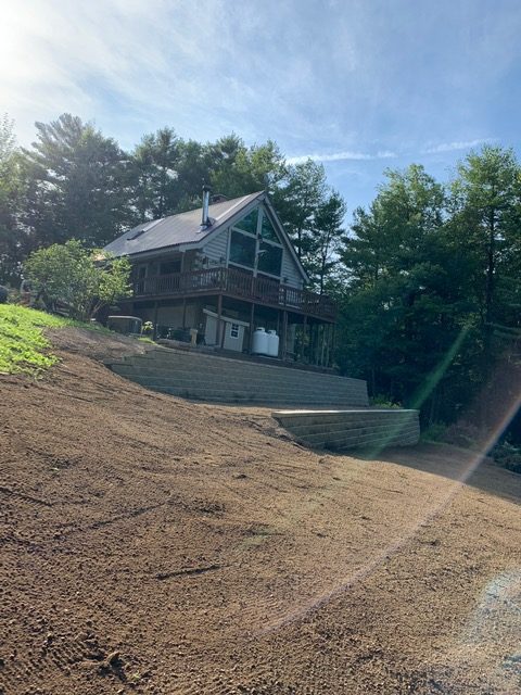 Cabin on hill with terraced retaining walls new hampshire